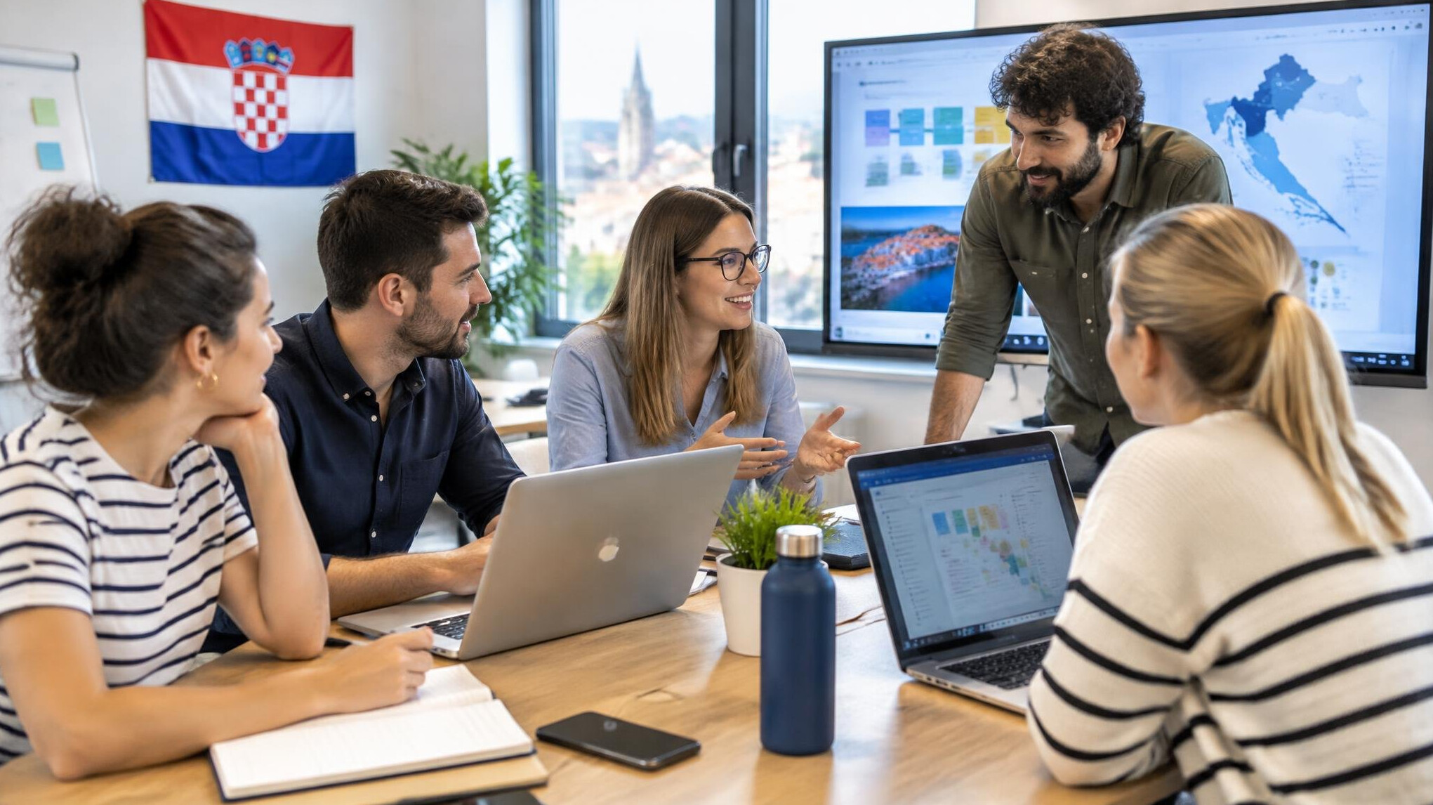 Group of colleagues studying together with laptops